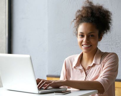 Woman sitting at a desk with a laptop - Life Skills Online Image