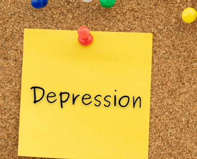 A photo of a post-it on a corkboard that says depression